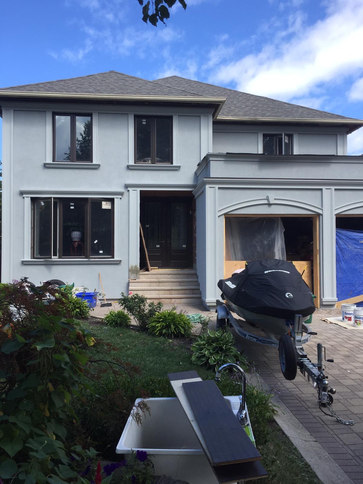 Grey EIFS stucco home with detailed exterior mouldings
